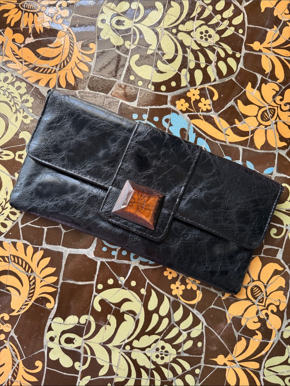 ARDEN B Black Leather Clutch Handbag with Amber Accent closure.